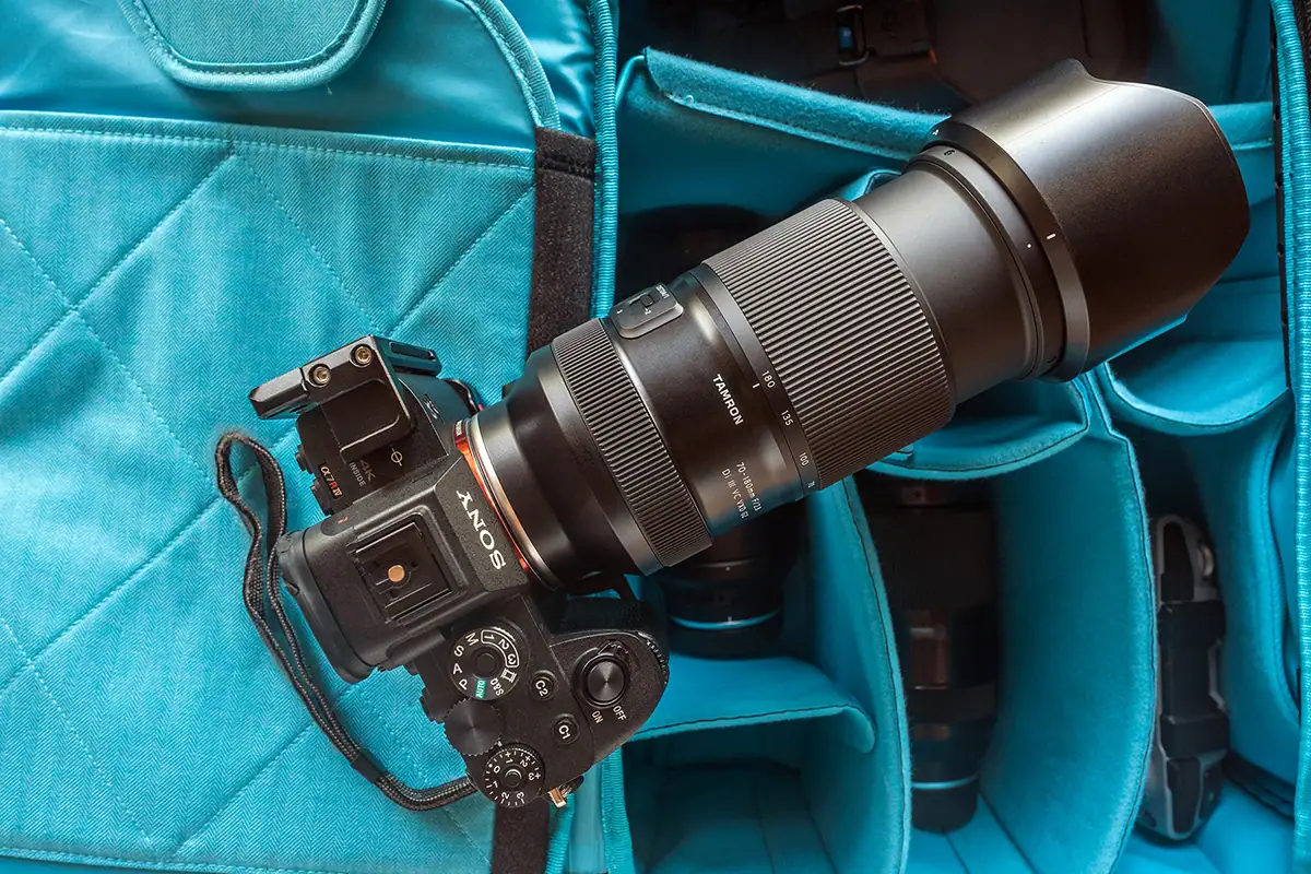 Sony mirrorless camera equipped with the Tamron 70-180mm F2.8 G2 lens placed inside a padded camera bag, showing the lens&rsquo;s size, build, and travel-ready design.