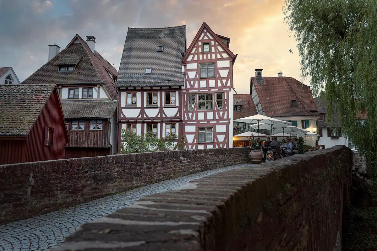 Traditional half-timbered houses in a European village at sunset, photographed with a Sony E-mount travel lens for architecture and destination photography.