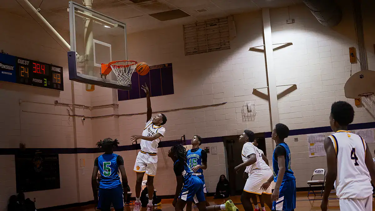A basketball player jumping up to make a shot.