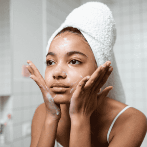 Woman applying skincare product, demonstrating skincare routine at Tonic Day Spa.