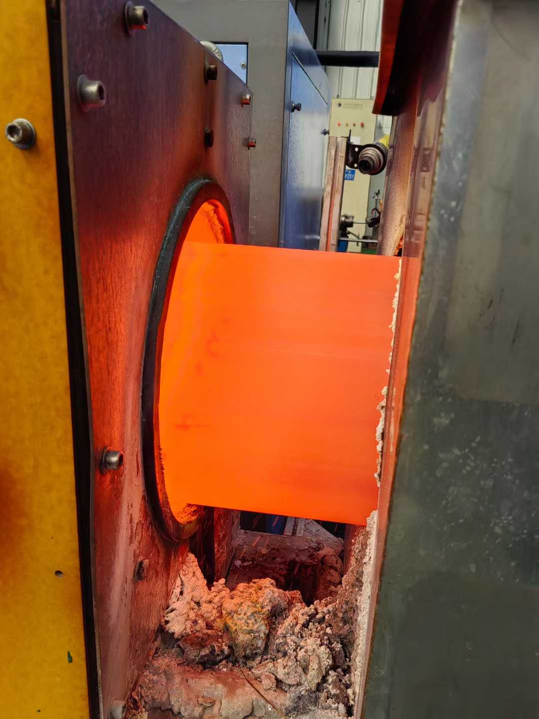 Close-up of the hot piercing process on a stainless steel billet