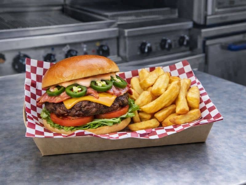 Chipotle jalapeño gourmet burger with chips from KK Catering burger van hire.
