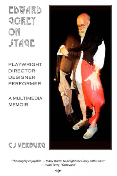 Photograph of Edward Gorey performing on stage with a puppet.