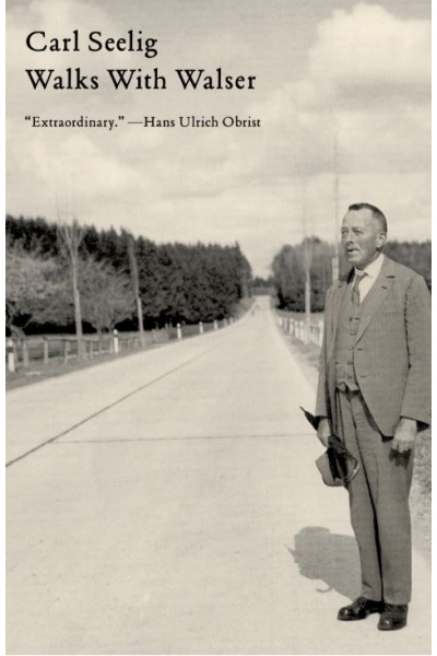 Historical photo of Carl Seelig walking outdoors on a rural road.