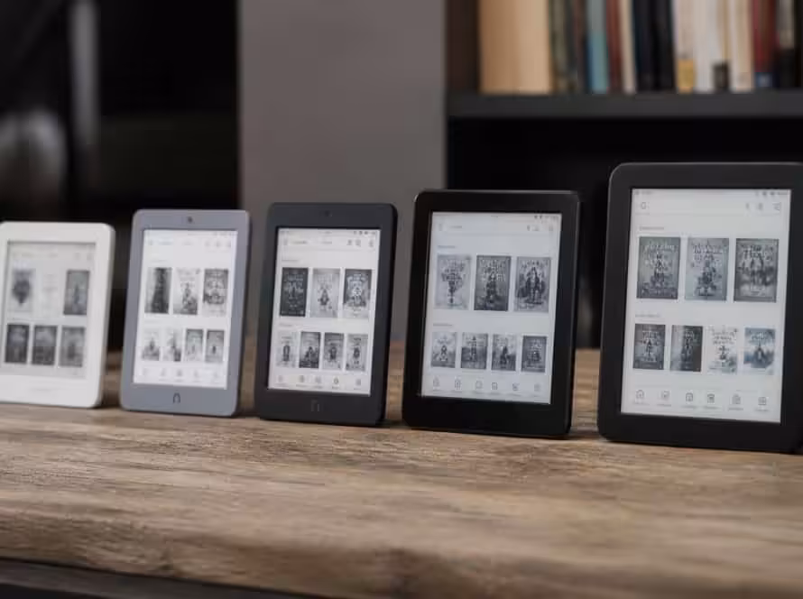 Multiple eBook readers showcasing digital books on a wooden shelf.