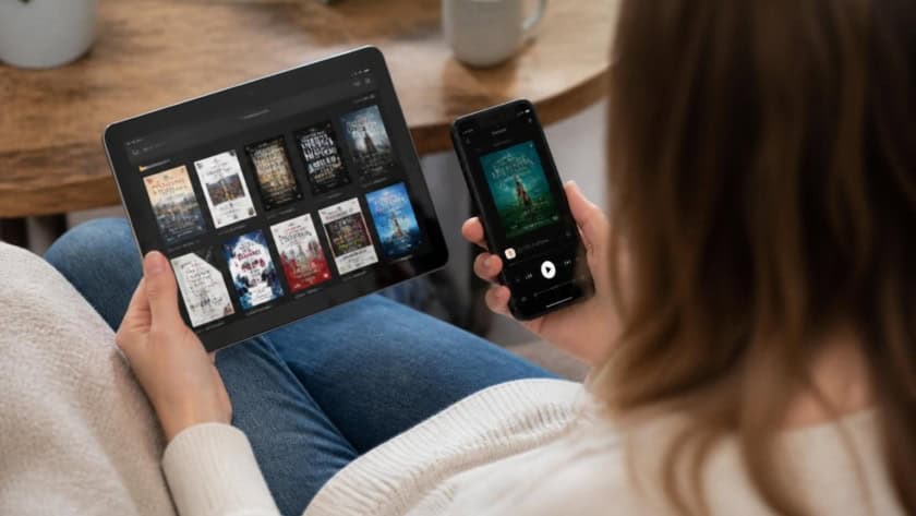 Person enjoying eBooks and audiobooks on digital devices at home.
