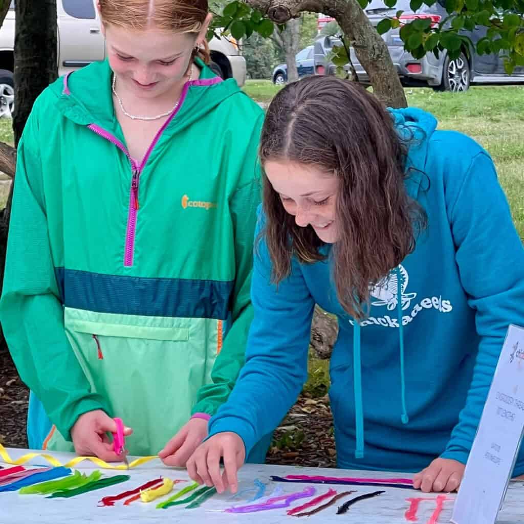 Children creating colorful art outdoors during Summer 2023 public art event.