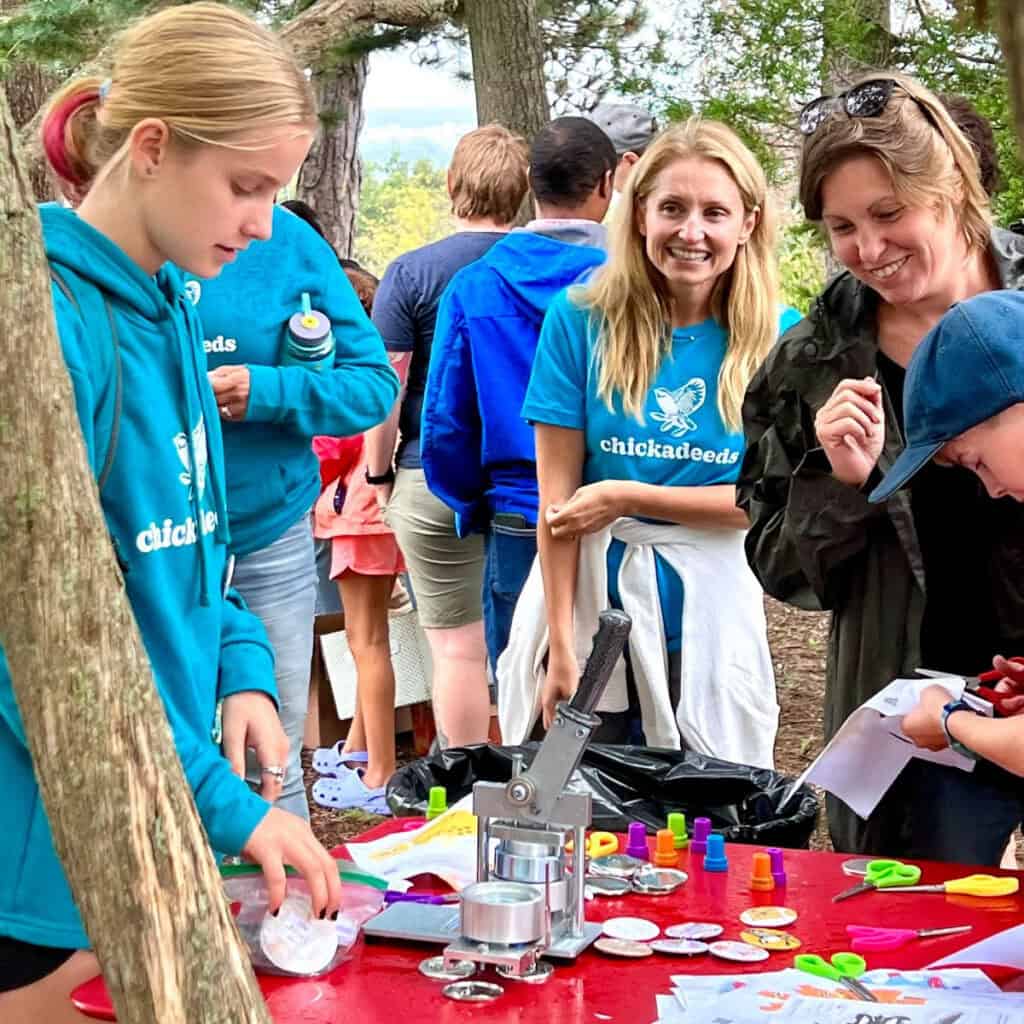 Group of people engaging in outdoor public art activity during summer 2023.