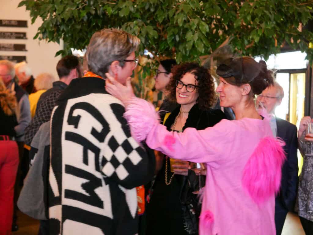 People enjoying networking at Catalyst 2024 event, vibrant atmosphere, indoor setting.