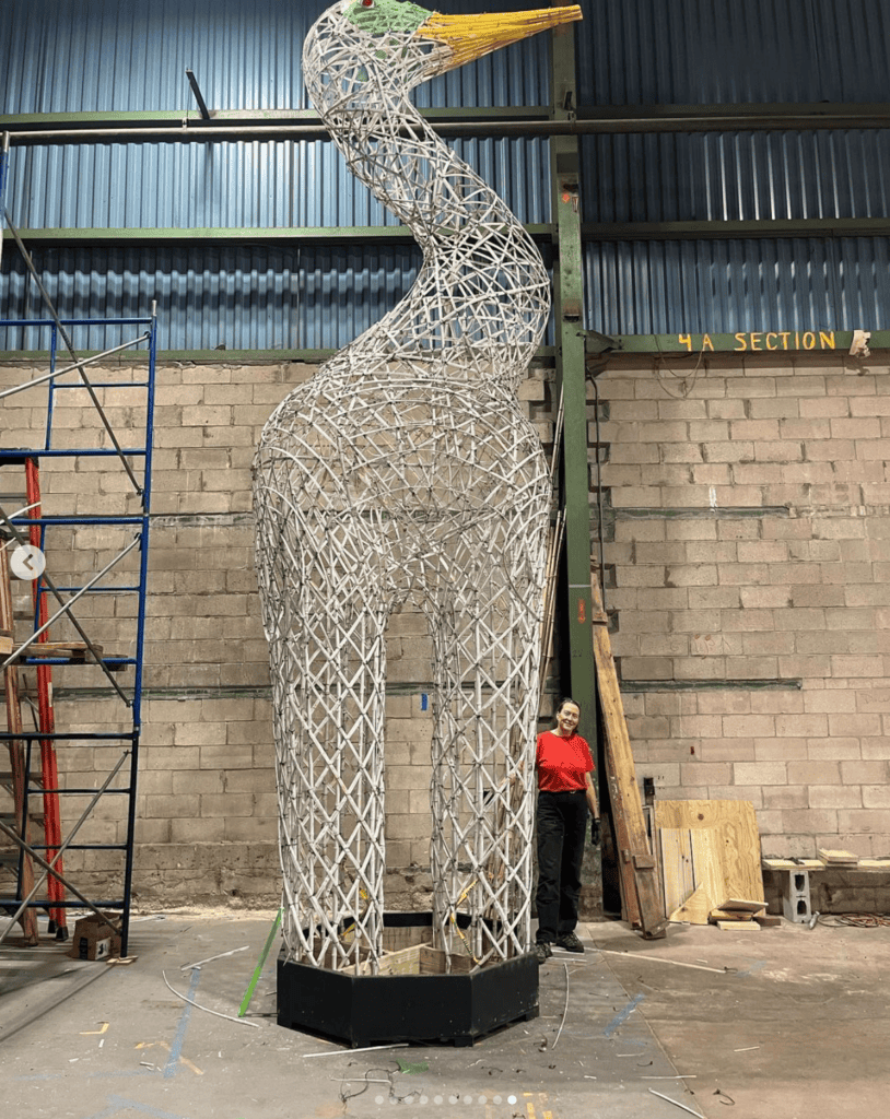 Giant wireframe giraffe sculpture titled "Dancing for Joy" in progress at Tempoart studio.
