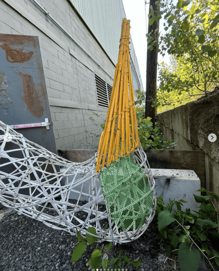 Dancing for Joy outdoor sculpture made of colorful woven materials and bamboo, inspired by community.