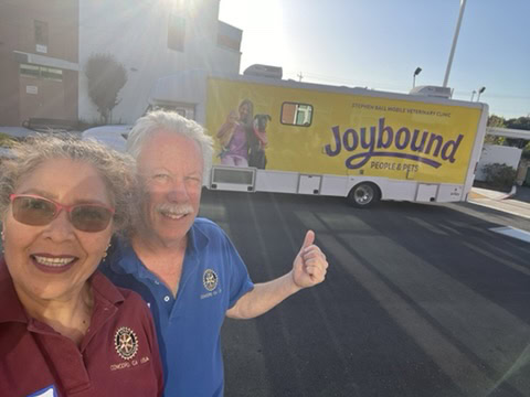 Joyful team members smiling with Joybound pet care truck in Walnut Creek, CA.