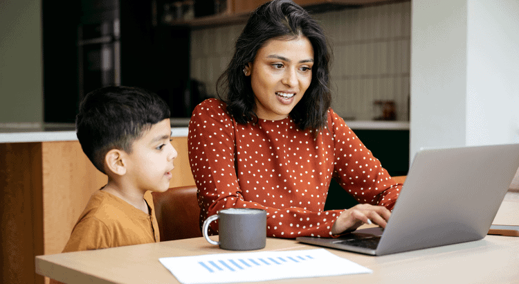 Walnut Creek real estate agent working on a laptop with a young boy at home.