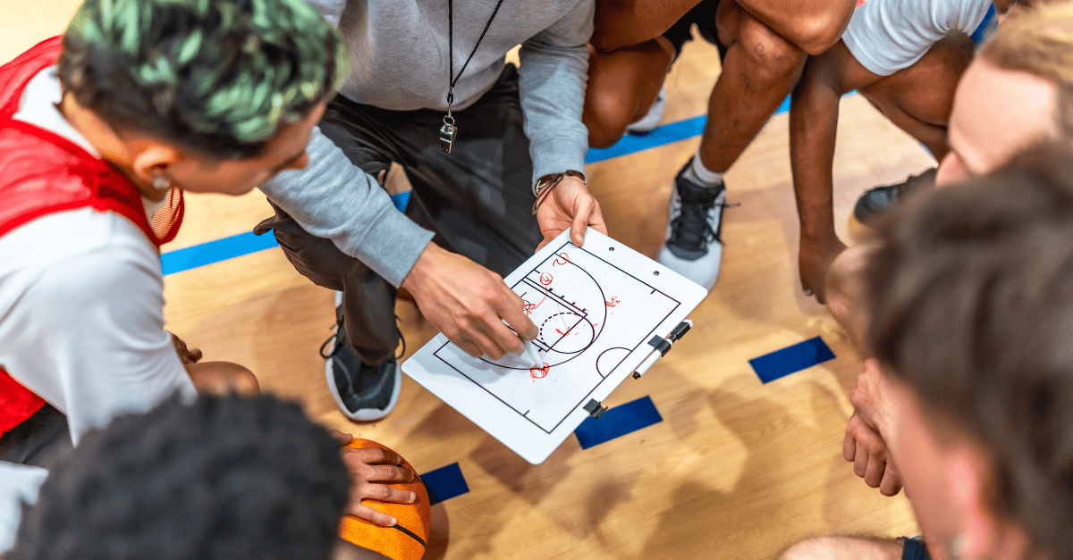 Executive leader coaching team using championship leadership lessons in high-stakes strategy session