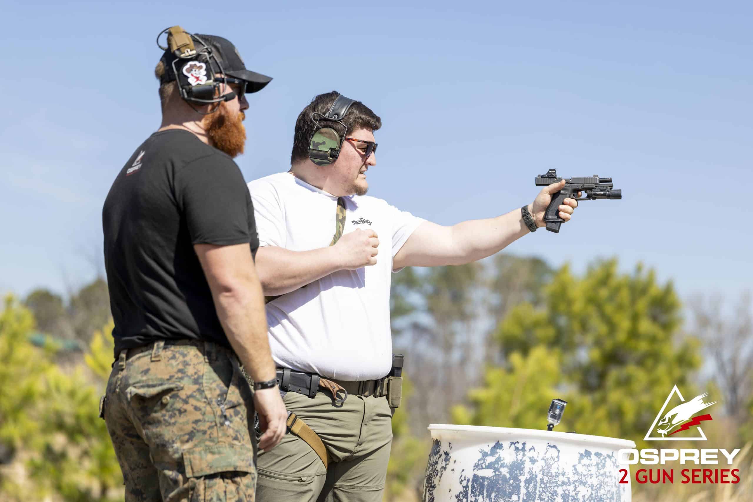 Competitor shooting pistol one handed at a 2 Gun competition hosted by Osprey Training Facility