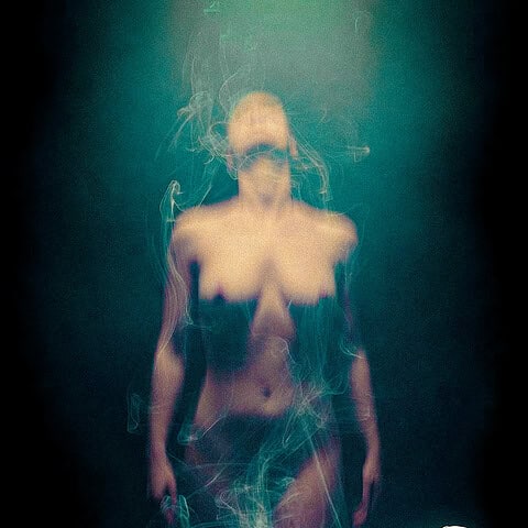 Surreal image of a woman on a bed with a ghostly figure rising, representing an out-of-body experience.