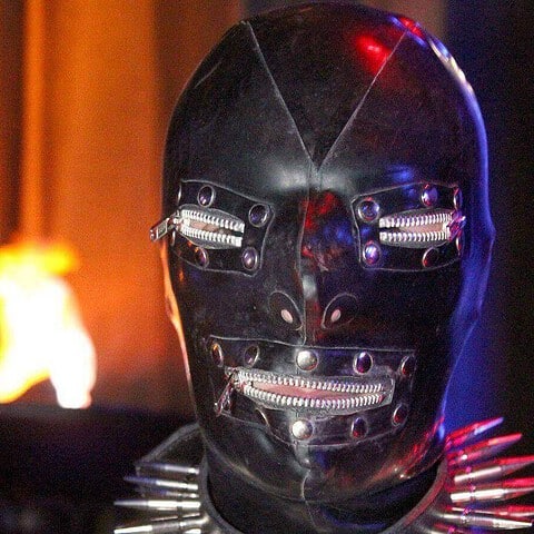Futuristic robot head with glowing red eyes and zippers