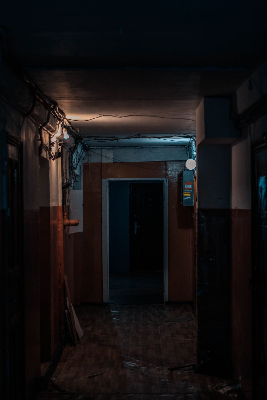 Dark Corridor Entwined With Doors To Apartments