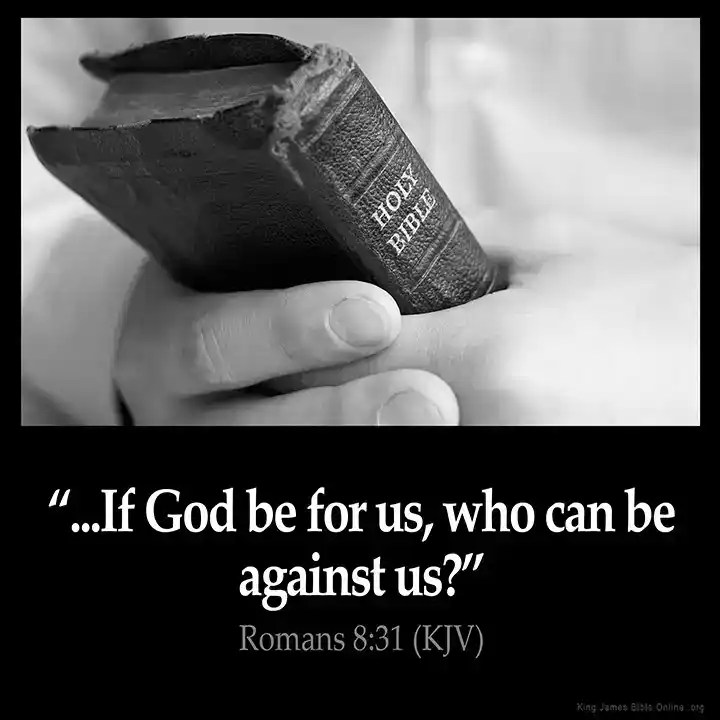 Person holding a Bible with a quote from Romans 8:31.