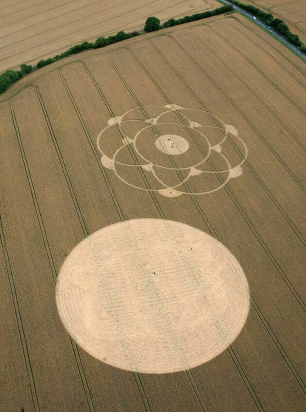 Aerial view of a crop circle with intricate geometric design in a wheat field.