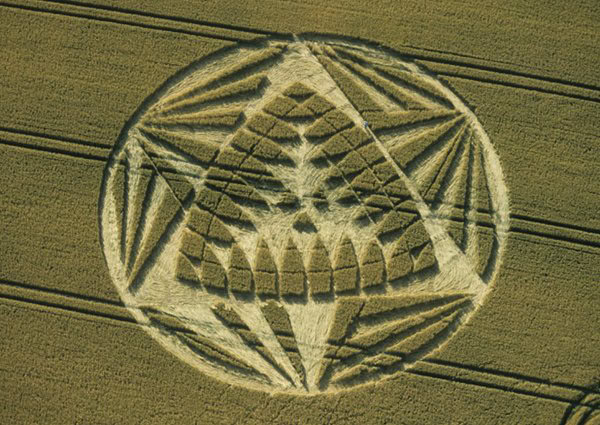 Sand art depicting fish and angel motifs symbolizing spiritual protection and divine connection.