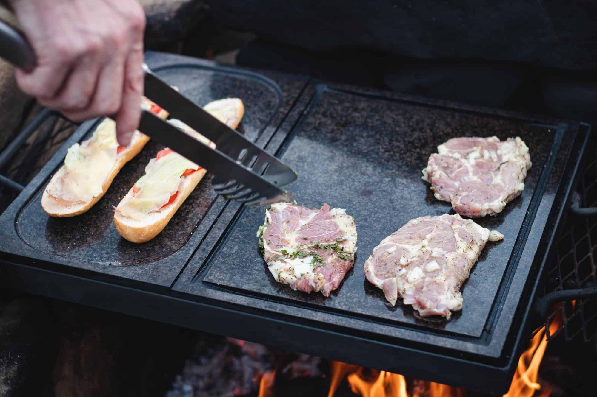 Grilling delicious meats and sandwiches on a flat-top grill at The Flames Galore Restaurant for flavorful barbecue.