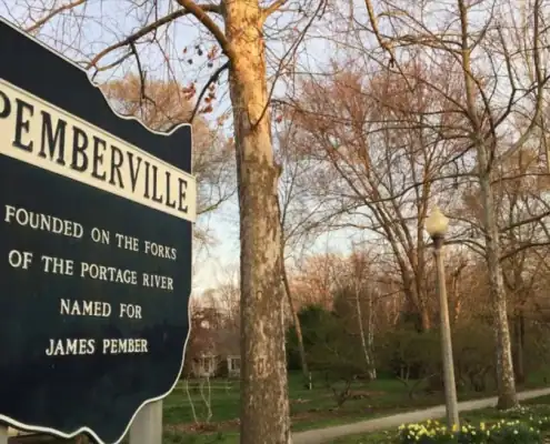 Historical sign in Pemberville, Ohio, highlighting the town's founding and connection to the Portage River.