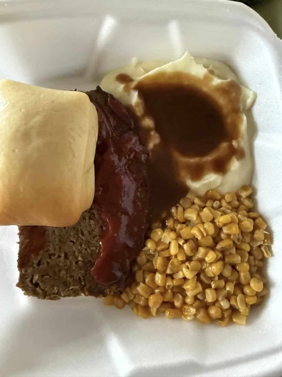 Delicious meatloaf served with corn, mashed potatoes, and gravy, perfect for a hearty meal in Fostoria.