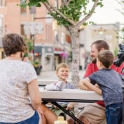 Young family relaxing in central Fostoria, Ohio's lively downtown area.