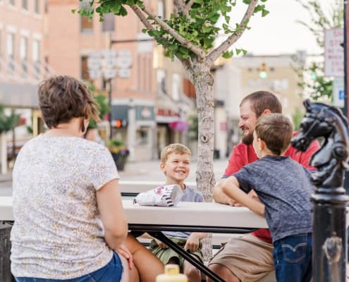 Young family relaxing in central Fostoria, Ohio's lively downtown area.