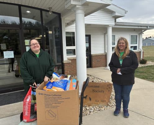 Friendly staff dropping supplies at local animal shelter.