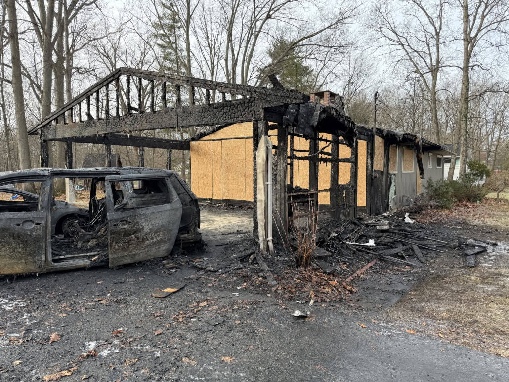 Charred house and burnt vehicle after a devastating fire in Fostoria, Ohio.