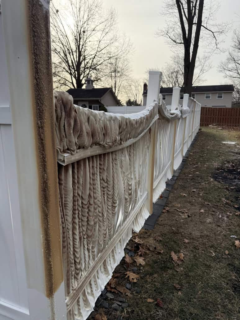 Frost damage to inflatable fencing in Fostoria, Ohio, with winter dead foliage and damaged fabric.