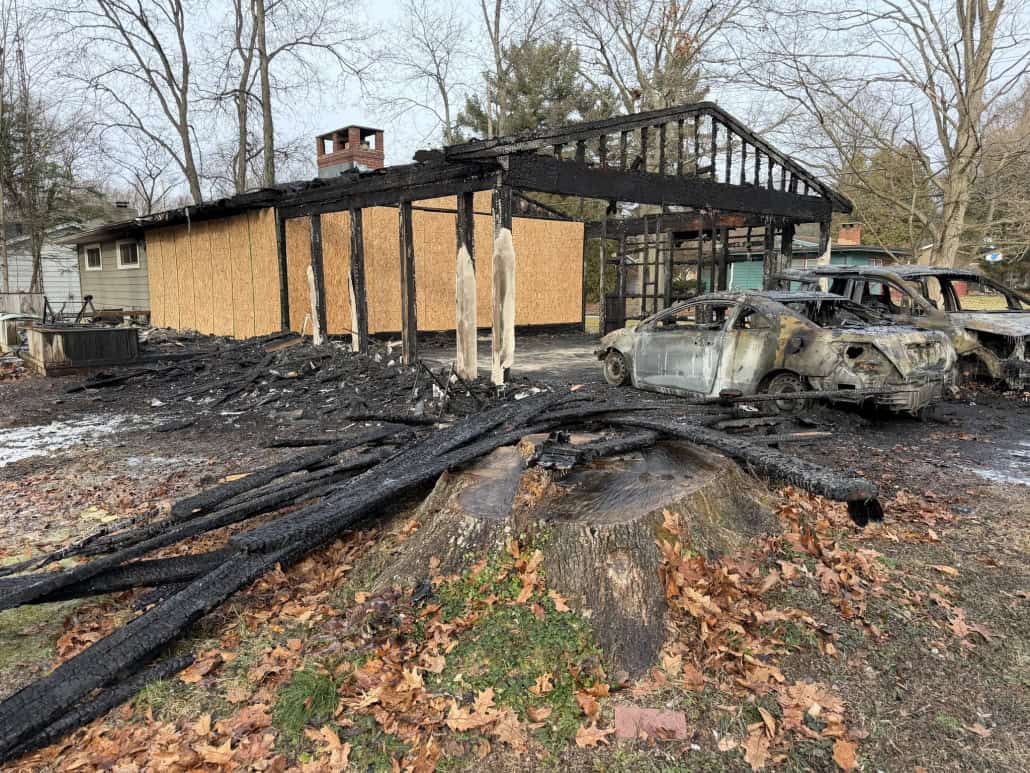 Charred cars and burnt remnants of a house after a fire in Fostoria, Ohio.