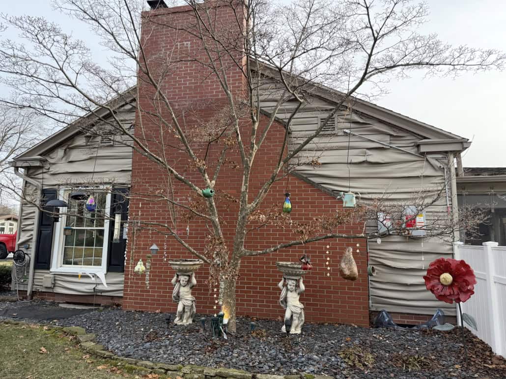 Colorful outdoor decorations adorn the house and yard.