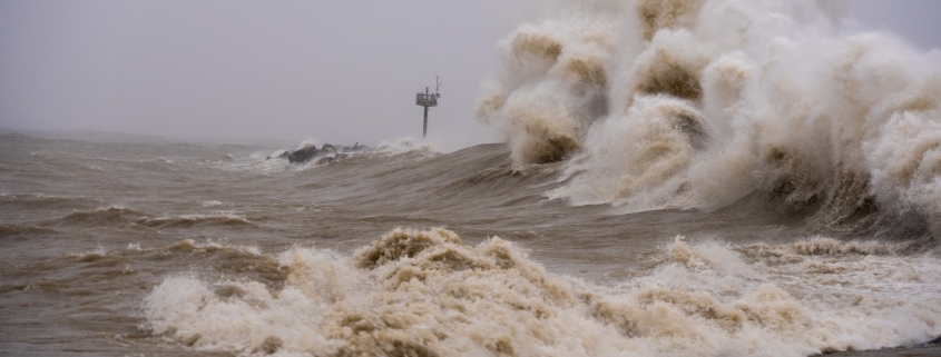 Wild stormy sea waves crashing during severe weather event.