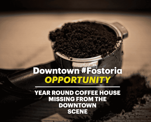 Freshly ground coffee beans in a scoop, emphasizing Fostoria's vibrant coffee culture.