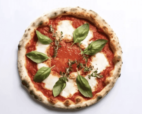 Delicious Margherita pizza topped with basil leaves, mozzarella, and fresh tomato sauce, ideal for food lovers.