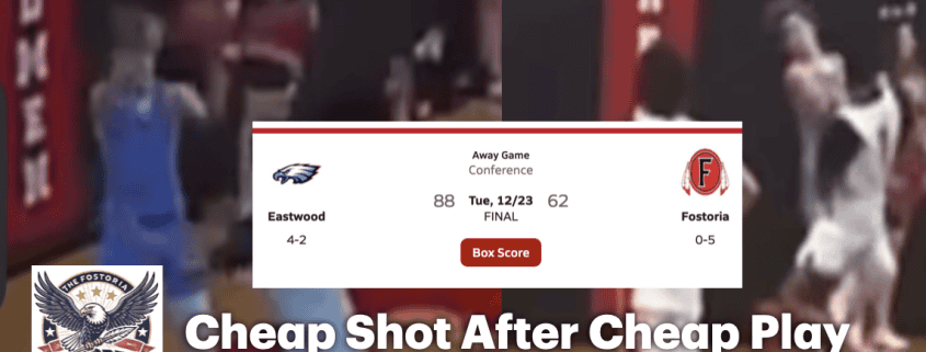 Crowd watches intense basketball game at Fostoria High School gymnasium.