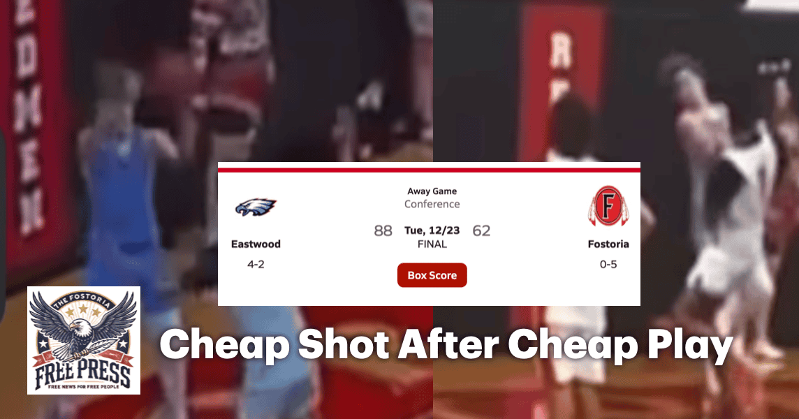 Crowd watches intense basketball game at Fostoria High School gymnasium.