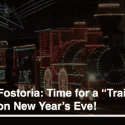 Colorful holiday train lights in Fostoria for New Year's celebration.