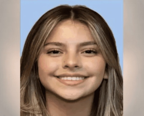 A close-up of a young girl with long blonde hair and a bright smile, conveying happiness; ideal for local news or community features.