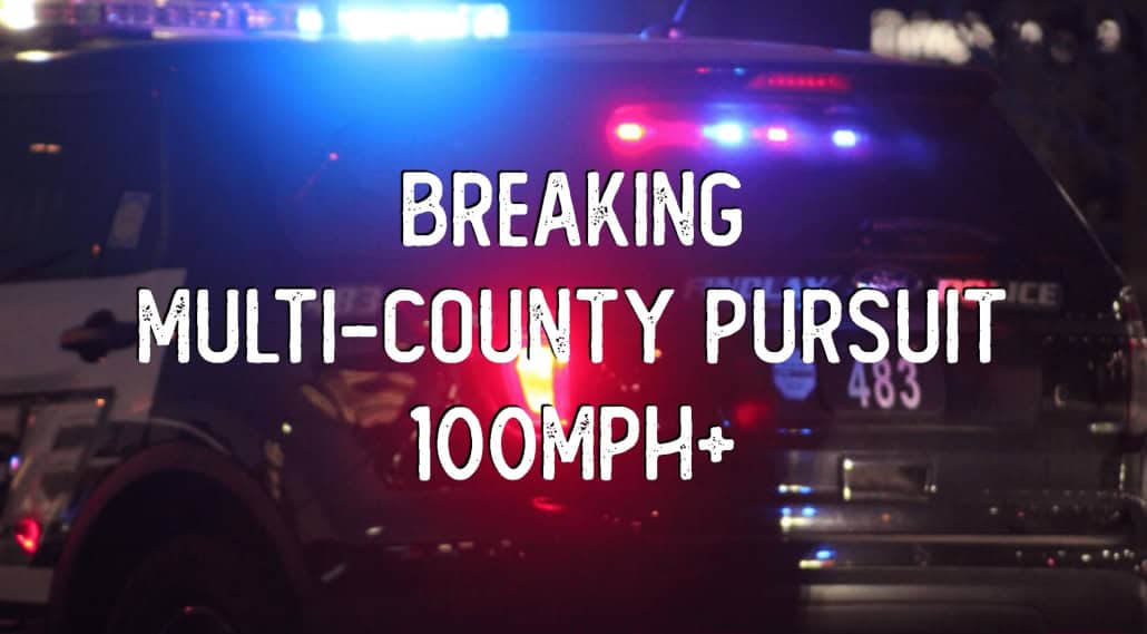 Police vehicle with flashing lights during intense pursuit.
