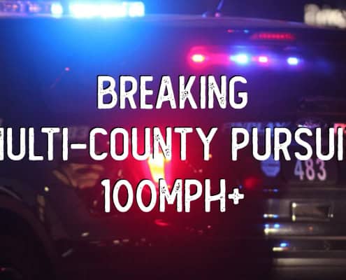 Police vehicle with flashing lights during intense pursuit.