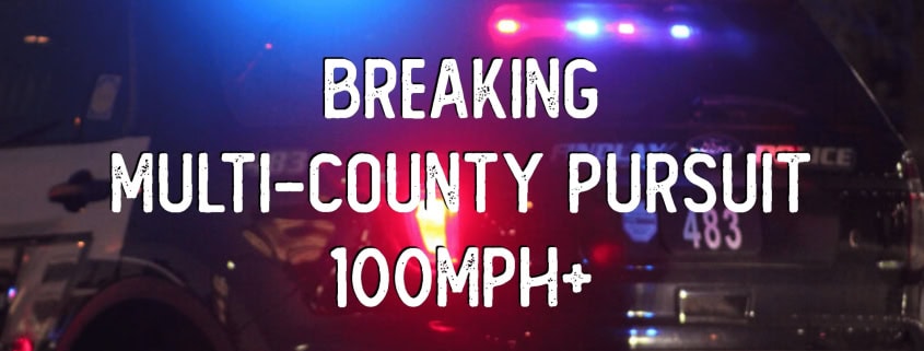 Police vehicle with flashing lights during intense pursuit.