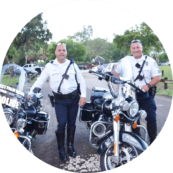 Two police officers with their police motorcycles.