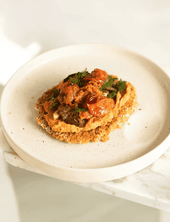 a white plate topped with food on top of a table