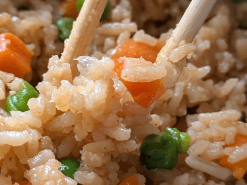A bowl of steaming hot gluten-free vegan Instant Pot fried rice with colorful vegetables.