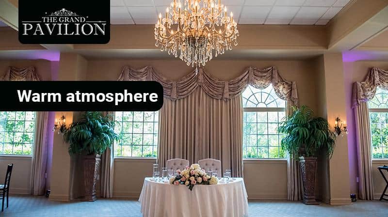 Elegant event venue with luxurious décor in a warm, inviting atmosphere at The Grand Pavilion.