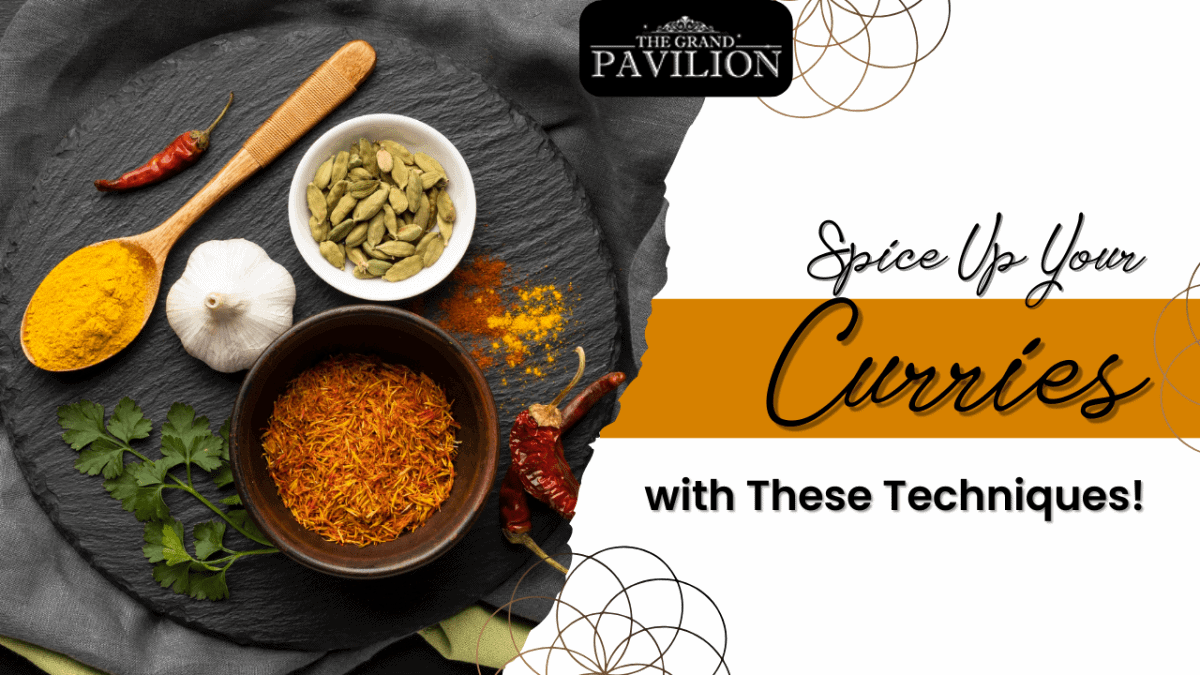 Golden curry spices with turmeric, garlic, cardamom, and dried chili peppers on a black slate background.